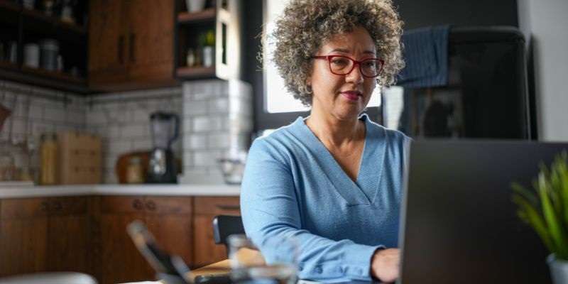 Woman creating her monthly budget on her laptop.