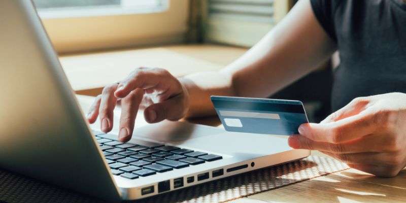 Woman shopping online with her credit card.