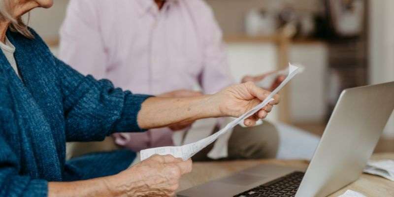 Old couple viewing their bank statements.