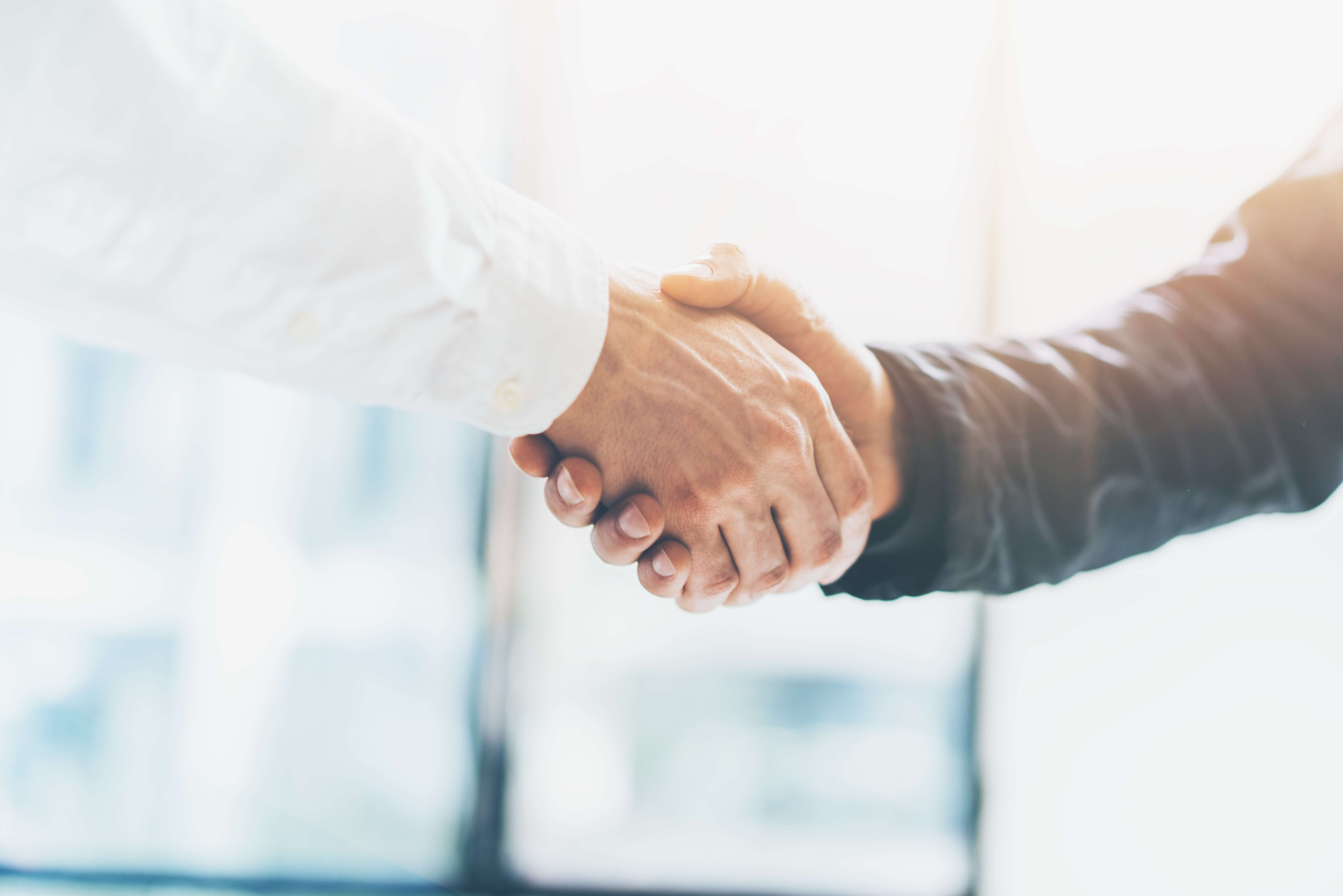 Two businessman shaking hands.