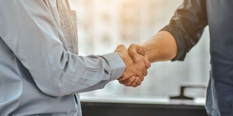 Two business men shaking hands.