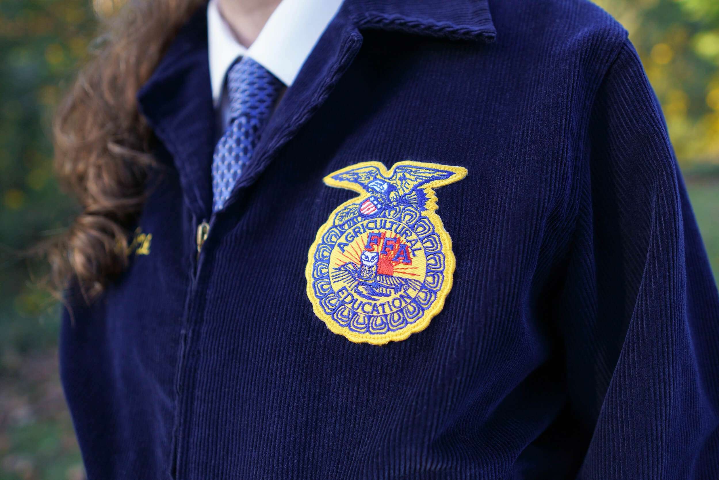 Close up of patch on person's jacket with Agricultural FFA Education written on it with a logo