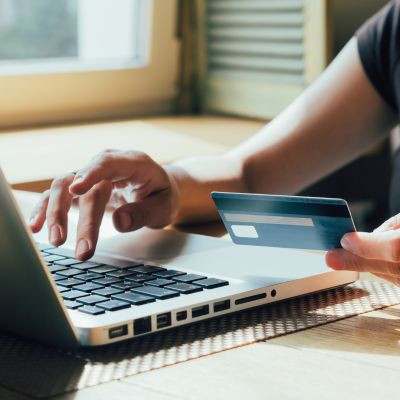 Woman shopping online using her credit card.