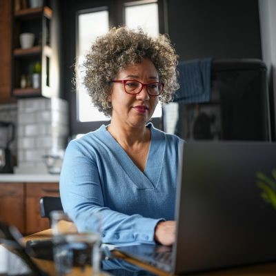 Woman creating an online budget using her laptop.