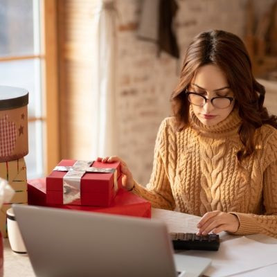 A woman creating her holiday budget.