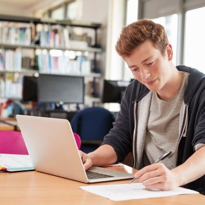 Male student filling out their student loan forms.