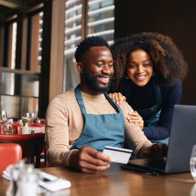 Business couple analyzing their business credit card.